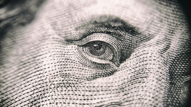 close up of Benjamin Franklin's eye as rendered on a hundred dollar bill
